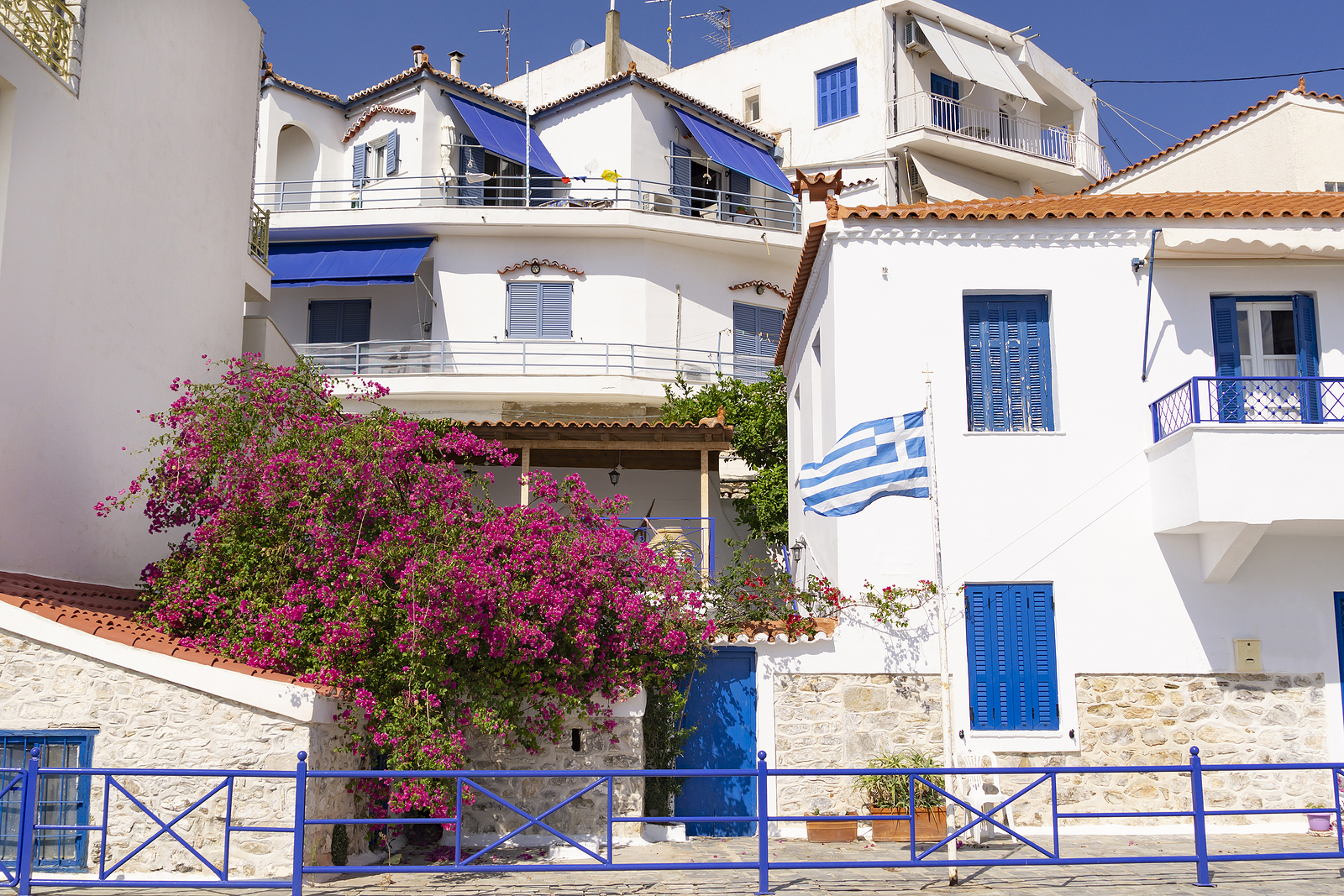 Typical White Walls And Blue Windows Of Greek Mediterranean Buil
