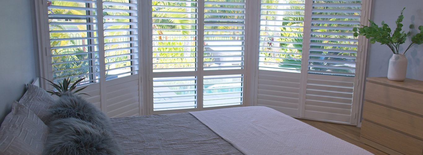 solid wood shutters - Luxury white indoor plantation shutters in bedroom