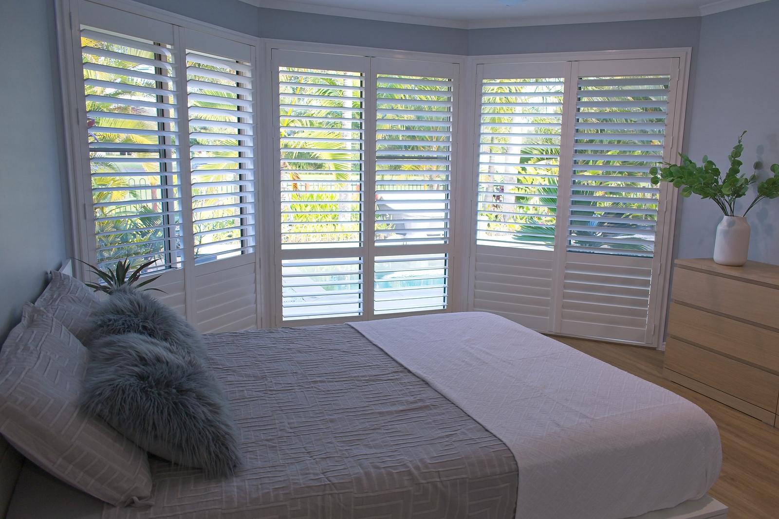 solid wood shutters - Luxury white indoor plantation shutters in bedroom