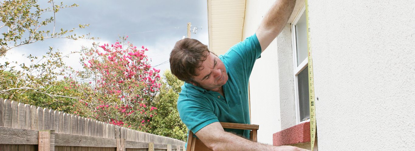 Shutter Company Brighton - carpenter measuring a window