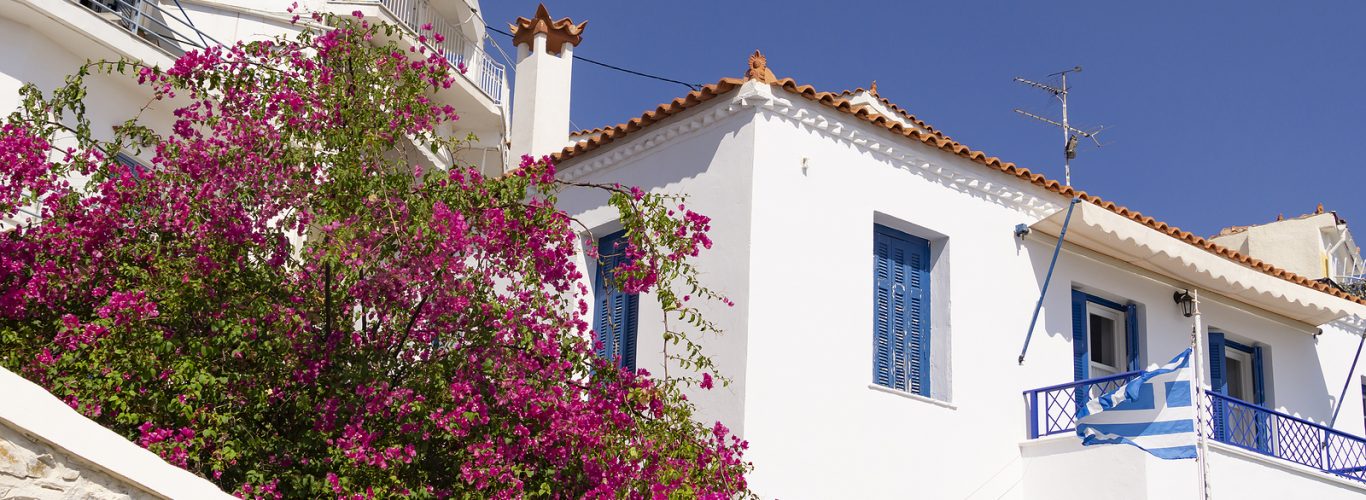 Tier on tier shutters bay window Brighton - blue windows of Greek Mediterranean building