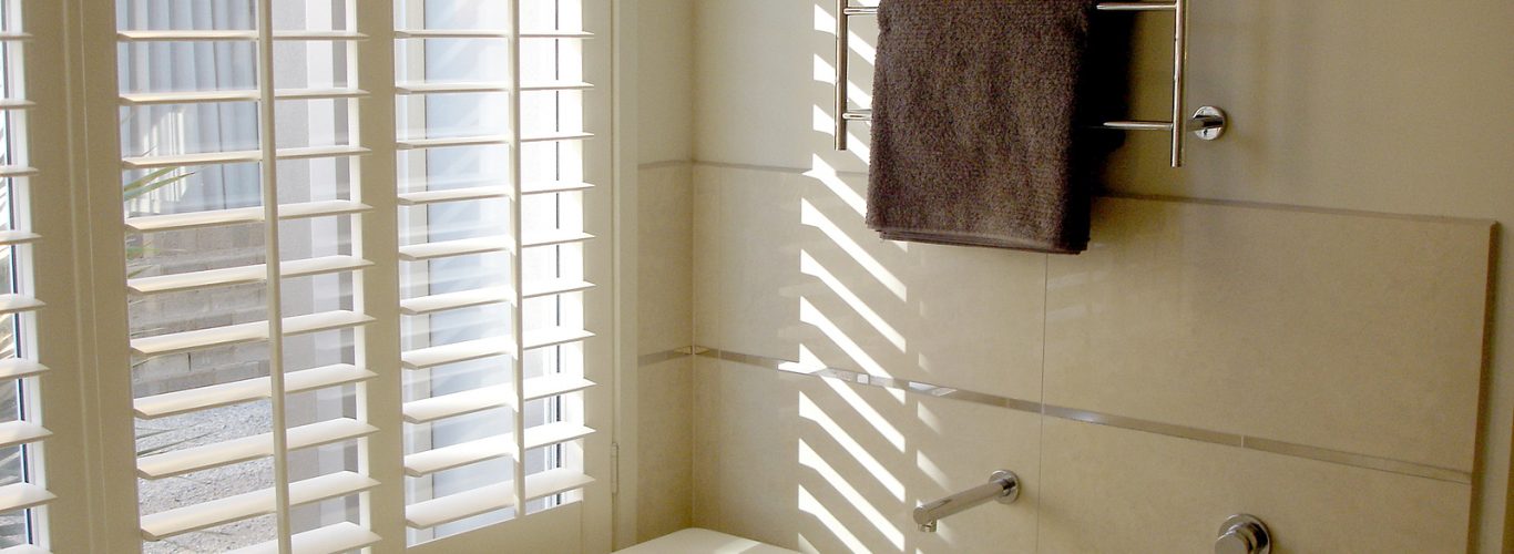 shutter company - bathroom with towels and white louvres