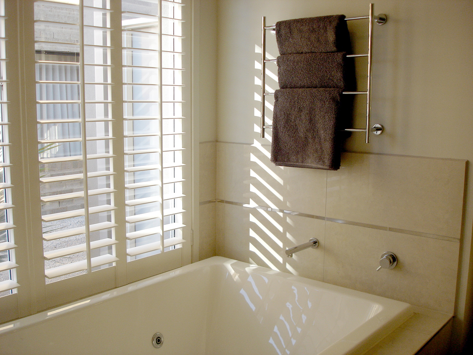 shutter company - bathroom with towels and white louvres