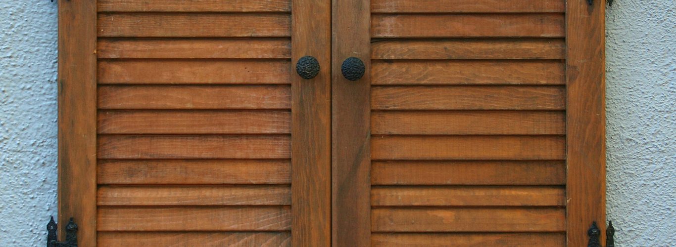 Solid Panel Shutters Brighton - window shutter on wall of a house