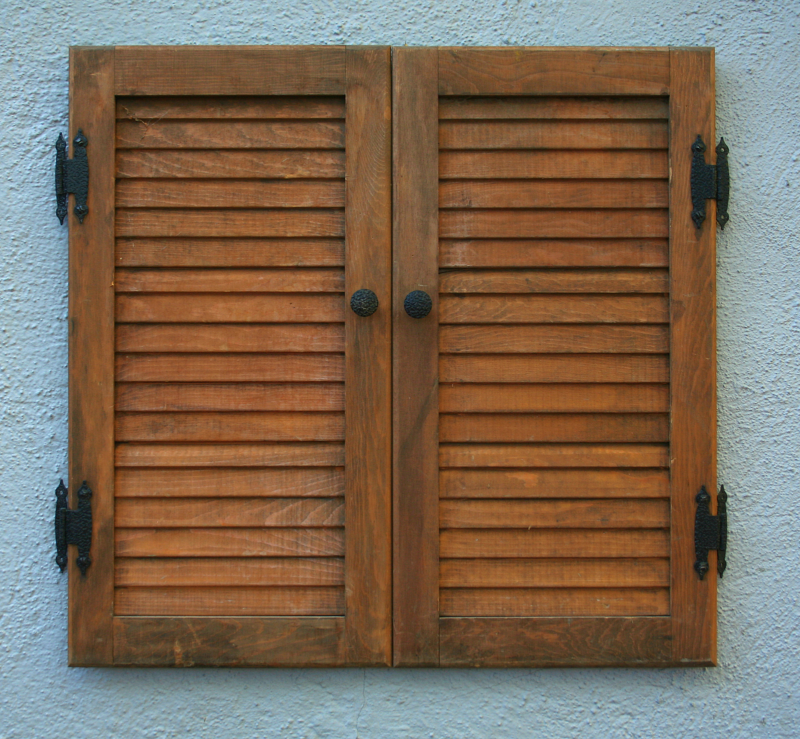 Solid Panel Shutters Brighton - window shutter on wall of a house