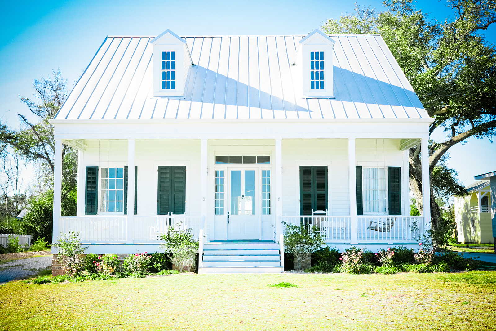 Full Height Shutters Brighton - white beach cottage with a metal roof