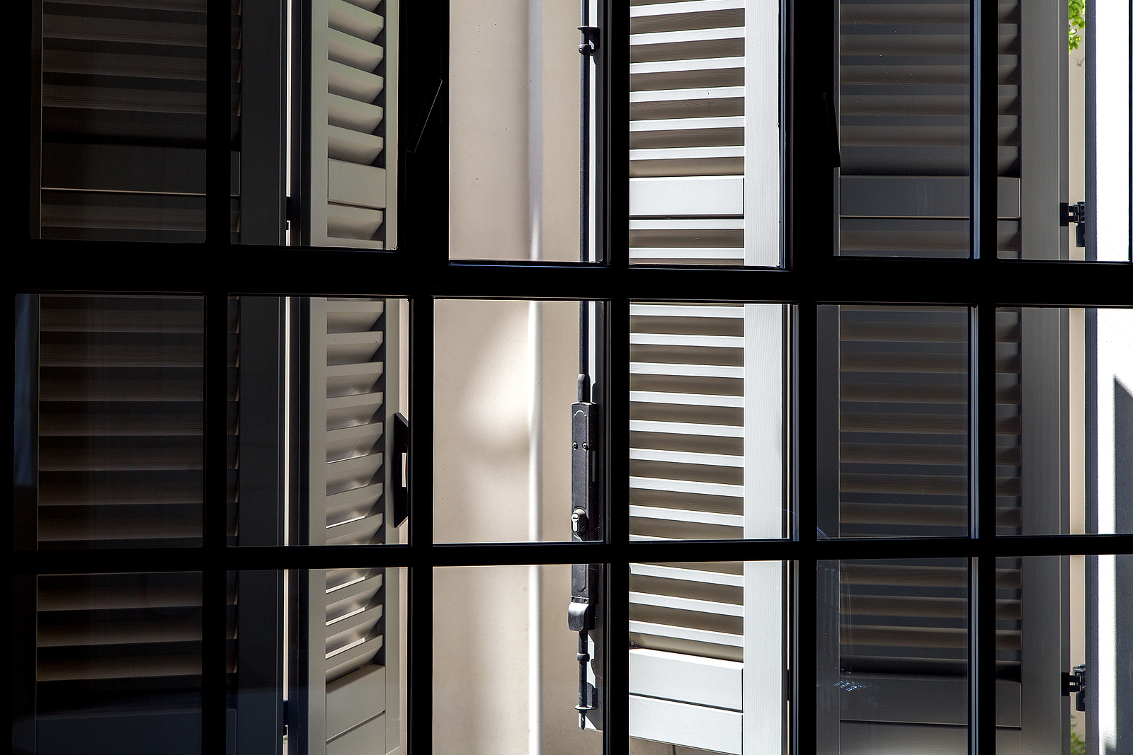 Solid wood shutters - gray wooden shutters on a sunny day view